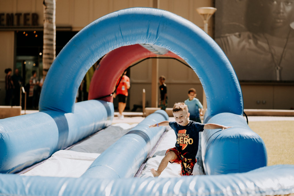 child playing on water slide at kidside water weekend