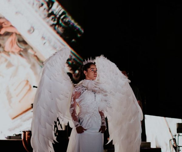 an angel with blue eyes and wings